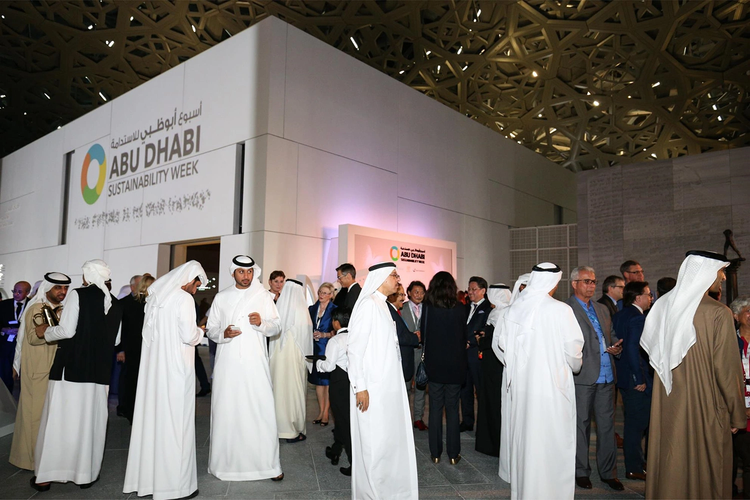 Delegates networking beside the Abu Dhabi Sustainability Week reception pavilion at Louvre Abu Dhabi