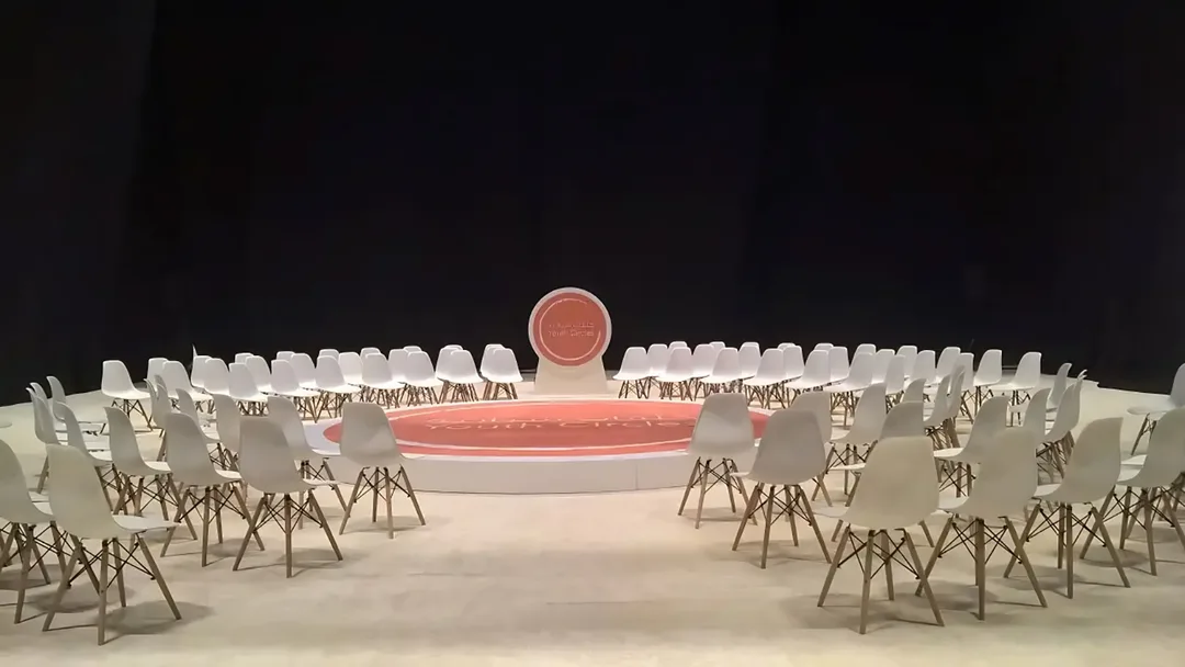 Youth sustainability discussion forum with modular seating circle and branded backdrop in Abu Dhabi