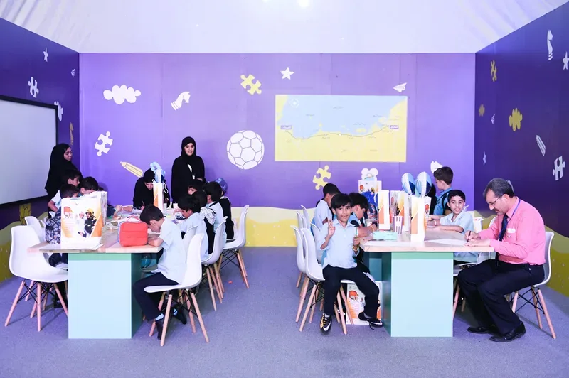 Families and children participating in creative educational art workshops on custom tables