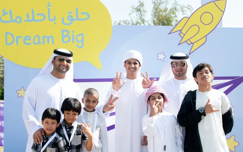 Media photo backdrop wall featuring fun cartoon characters and national event branding