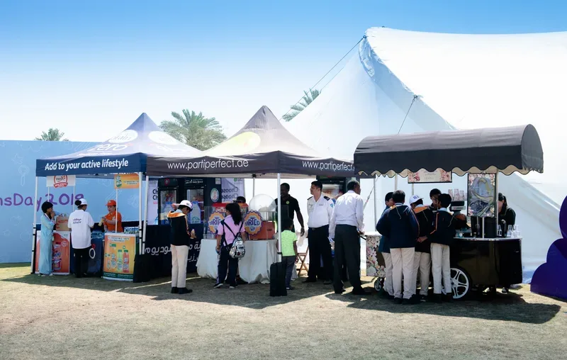 Catering food park with shaded family picnic benches and healthy snack service counters