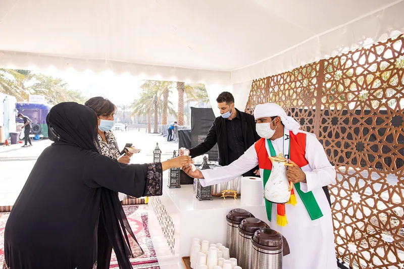 Evolution Events Emirati coffee station serving guests during ADNOC’s National Day family event