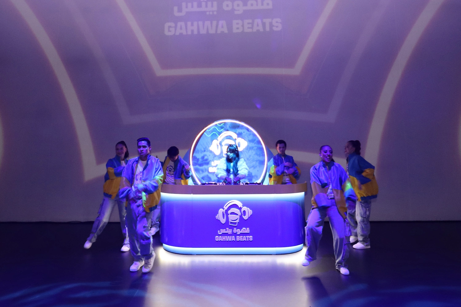 Standalone circular event branding backdrop panel illuminated with warm accent spotlighting