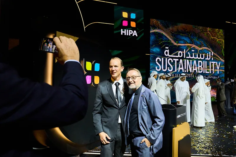 Winning photographers receiving awards on stage during international ceremony in Dubai