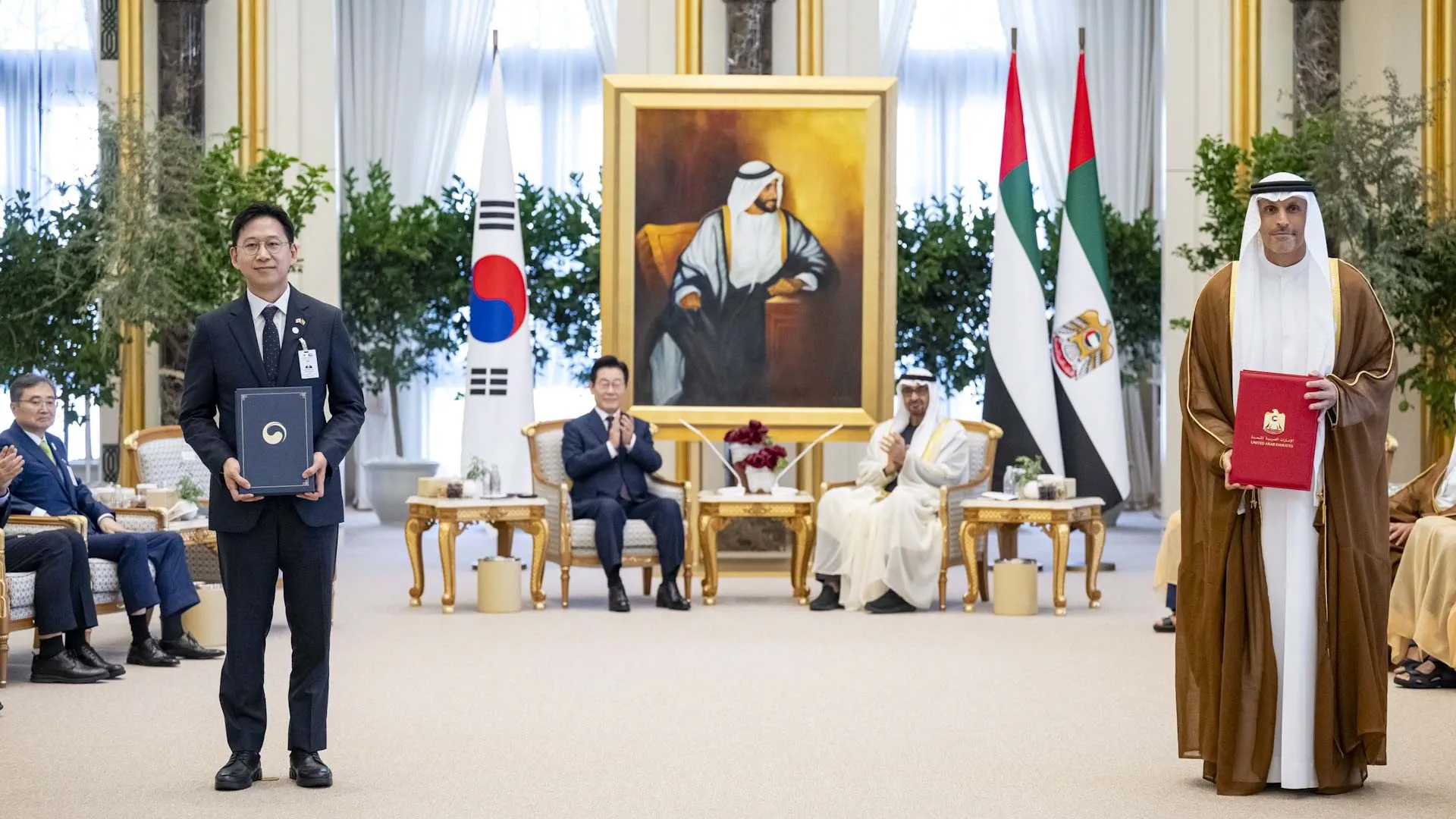 Bilateral agreement signing ceremony table with custom floral arrangements and microphones
